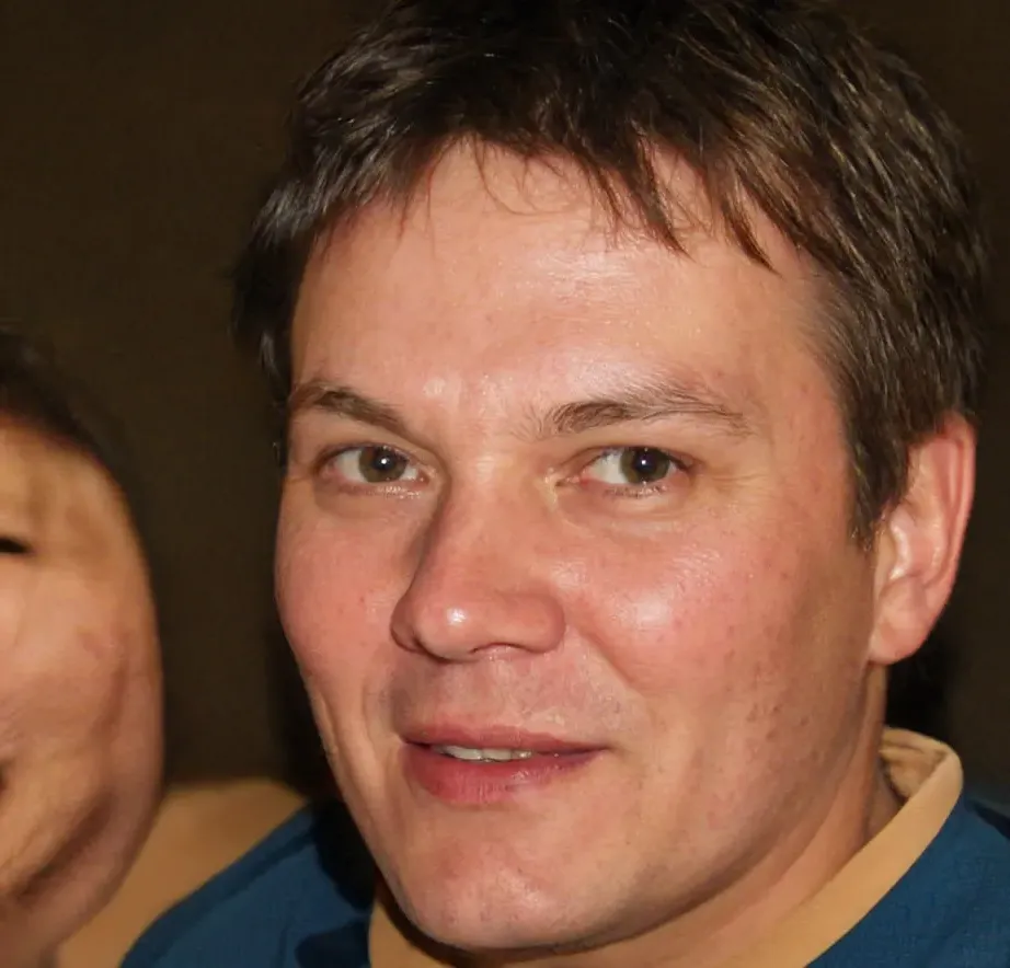 Elvis Frog in Vegas Smiling man, brown hair, hazel eyes, blue shirt